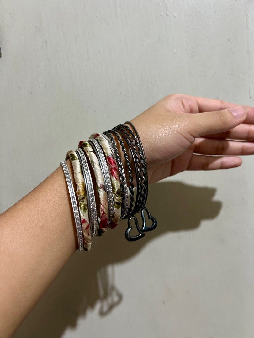 Assorted Bangles Set (Category: Bracelets) located in Manila. Submitted by ponyows (Listing ID 1412427220, Image 1). Description: Collection of bangles and bracelets, including some fabric-wrapped bangles and a set of gunmetal bangles with heart charms. mop: gcash/bpi mod: lalamove / j&t location: sampaloc manila no return & refund .
