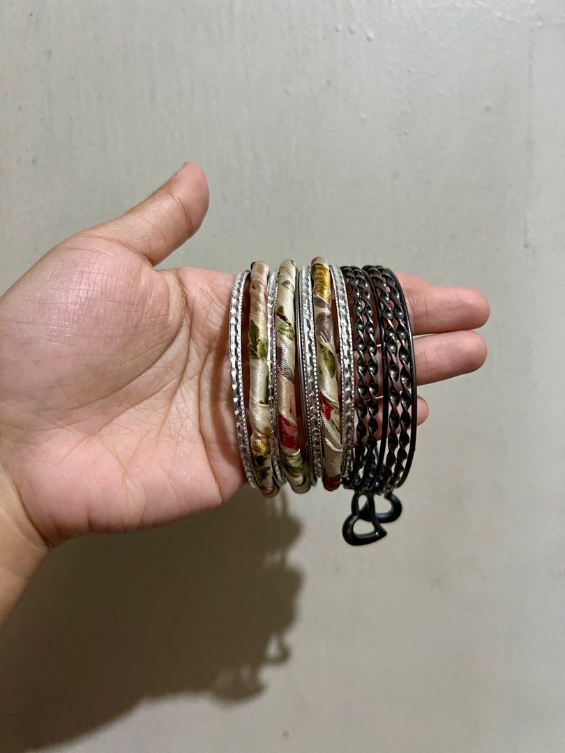 Assorted Bangles Set (Category: Bracelets) located in Manila. Submitted by ponyows (Listing ID 1412427220, Image 2). Description: Collection of bangles and bracelets, including some fabric-wrapped bangles and a set of gunmetal bangles with heart charms. mop: gcash/bpi mod: lalamove / j&t location: sampaloc manila no return & refund .