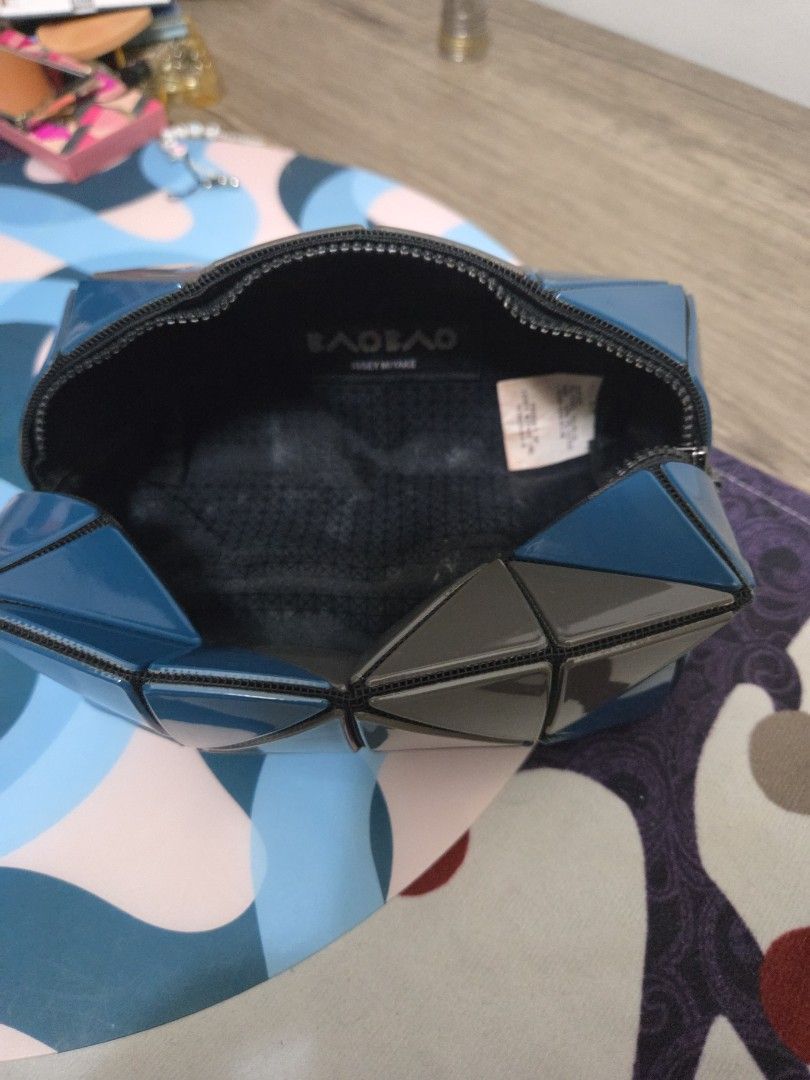 Authentic Bao Bao Issey Miyake Clutch (Category: Luxury Bags & Wallets) located in Manila. Submitted by sterling_grace (Listing ID 1412383567, Image 2). Description: - Bao Bao Issey Miyake clutch bag - Unique geometric design - Color: Blue and gray - Triangular shape - Secure zipper closure - Spacious interior - Brand name visible inside - Includes small tag - Perfect for any occasion.