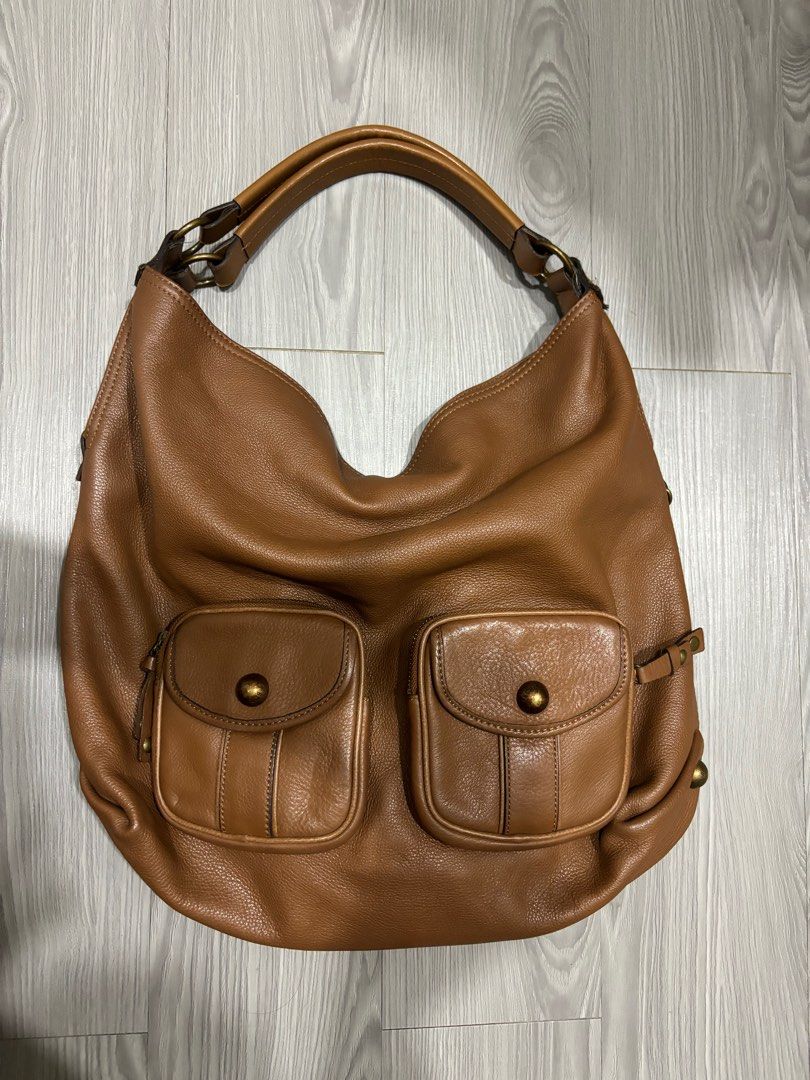 BCBG Vintage Brown Leather Bag (Category: Shoulder Bags) located in Manila. Submitted by prelovedbymfl (Listing ID 1412478794, Image 1). Description: - very good quality - genuine leather - fits alot - has inner compartments - bought frm ig thrift - minor cracks in opening.