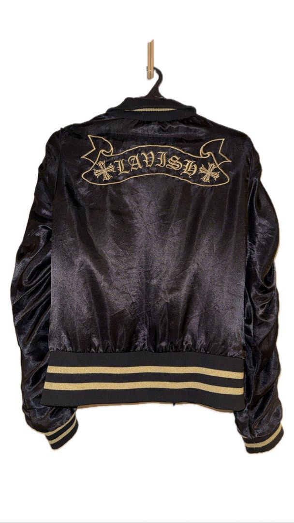 Black and Gold Bomber Jacket (Category: Coats, Jackets and Outerwear) located in Binan City. Submitted by incairo (Listing ID 1412351452, Image 2). Description: - Black bomber jacket - Gold accents - Skull design on front - "LAVISH" embroidered on back - Zipper closure - Ribbed cuffs and hem - Gold stripes on sleeves and collar.