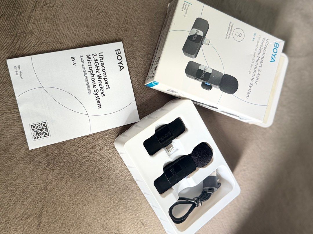 BOYA BY-V Ultracompact Wireless Microphone System (Category: Microphones) located in Mandaluyong City. Submitted by mc.closet_ (Listing ID 1412493586, Image 1). Description: - BOYA BY-V Ultracompact Wireless Microphone System - Designed for iOS devices - Includes: - Transmitter - Receiver (Lightning Connector) - Charging Cable - User Manual - Box - Microphone Color: Black The BOYA BY-V1 is a compact wireless microphone designed for iOS devices wi