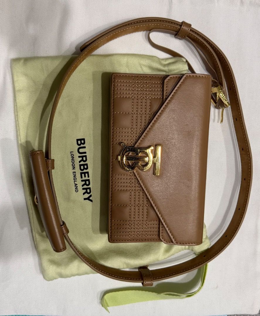 Burberry Quilted TB Belt Bag (Category: Luxury Bags & Wallets) located in Las Pinas. Submitted by eyes_jade (Listing ID 1412431641, Image 3). Description: - Burberry belt bag - Quilted design - TB logo - Tan color - Gold-toned hardware - Flap closure - Adjustable belt - Includes dust bag - Compact and stylish Size: 2cm x 10cm x 18cm.