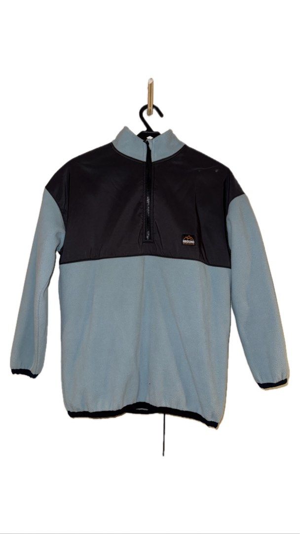 Colorblock Fleece Pullover Jacket (Category: Activewear) located in Binan City. Submitted by incairo (Listing ID 1412351449, Image 1). Description: - Colorblock design: Black upper panel, light blue lower panel. - Quarter-zip closure. - Features a small logo on the chest. - Elastic cuffs for a snug fit. - Drawstring hem for adjustable comfort. - Made from fleece material. - Comfortable and stylish outerwear..
