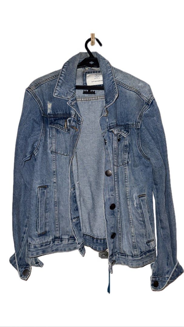 Denim Jacket (Category: Coats, Jackets and Outerwear) located in Binan City. Submitted by incairo (Listing ID 1412354595, Image 1). Description: - Classic denim jacket - Button-down front and collar - Long sleeves with buttoned cuffs - Two front pockets - Distressed detail on the back - Versatile for various outfits.
