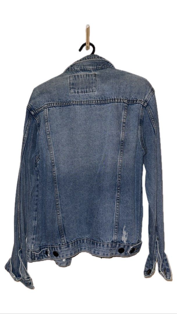 Denim Jacket (Category: Coats, Jackets and Outerwear) located in Binan City. Submitted by incairo (Listing ID 1412354595, Image 2). Description: - Classic denim jacket - Button-down front and collar - Long sleeves with buttoned cuffs - Two front pockets - Distressed detail on the back - Versatile for various outfits.