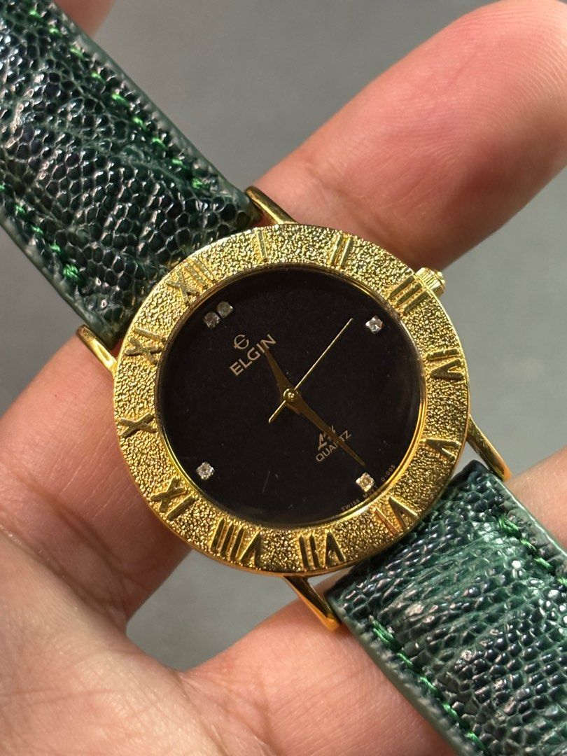 Elgin Roman Quartz (Category: Men's Watches) located in Manila. Submitted by soughtafterseconds (Listing ID 1412495334, Image 2). Description: Elgin Roman Quartz This Elgin Quartz delivers all the high-end vibes with its textured gold-tone bezel and crisp Roman numerals. That deep black dial with diamond accents at the poles is the ultimate “dress up” finishing touch. Carrying the name of a legendary American watchmaker, this modern classic is pr