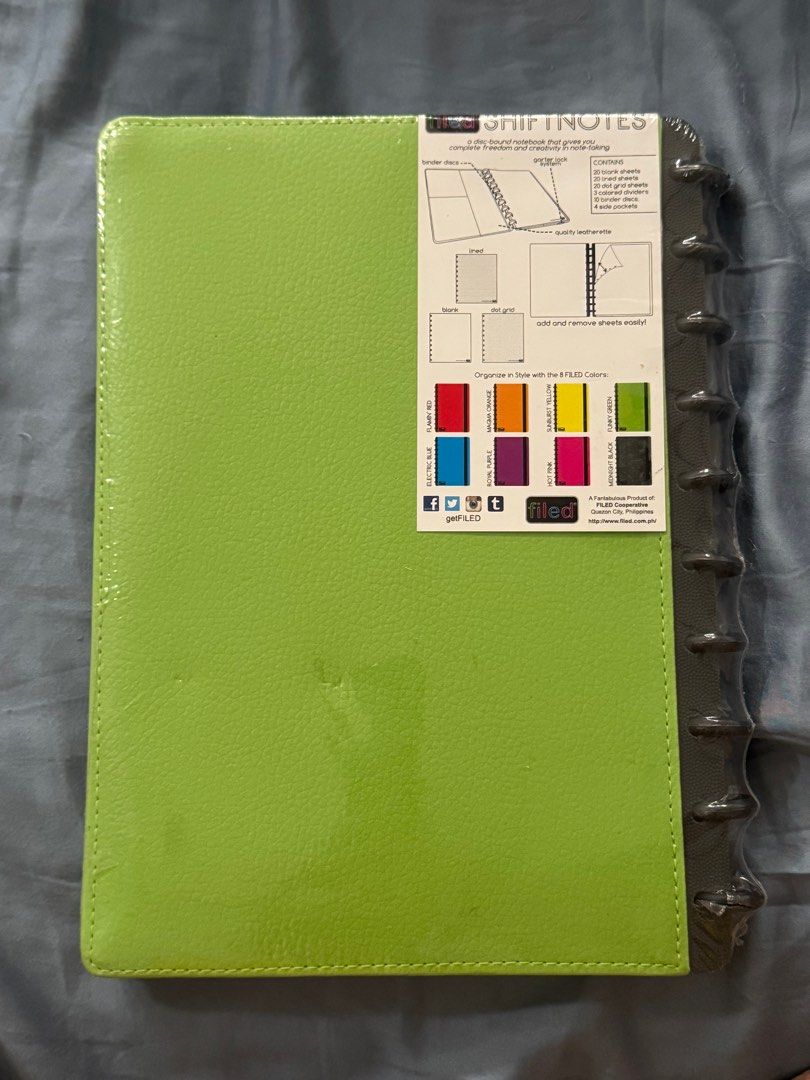 Filed Shiftnotes Notebook Binder (Category: Stationery & School Supplies) located in Manila. Submitted by miggya31 (Listing ID 1412512928, Image 2). Description: - New Filed Shiftnotes notebook - Bright green cover - Dark gray spine and vertical stripe - Disc-bound system for easy organization - Still in original packaging - Back of notebook shows sheet color options.