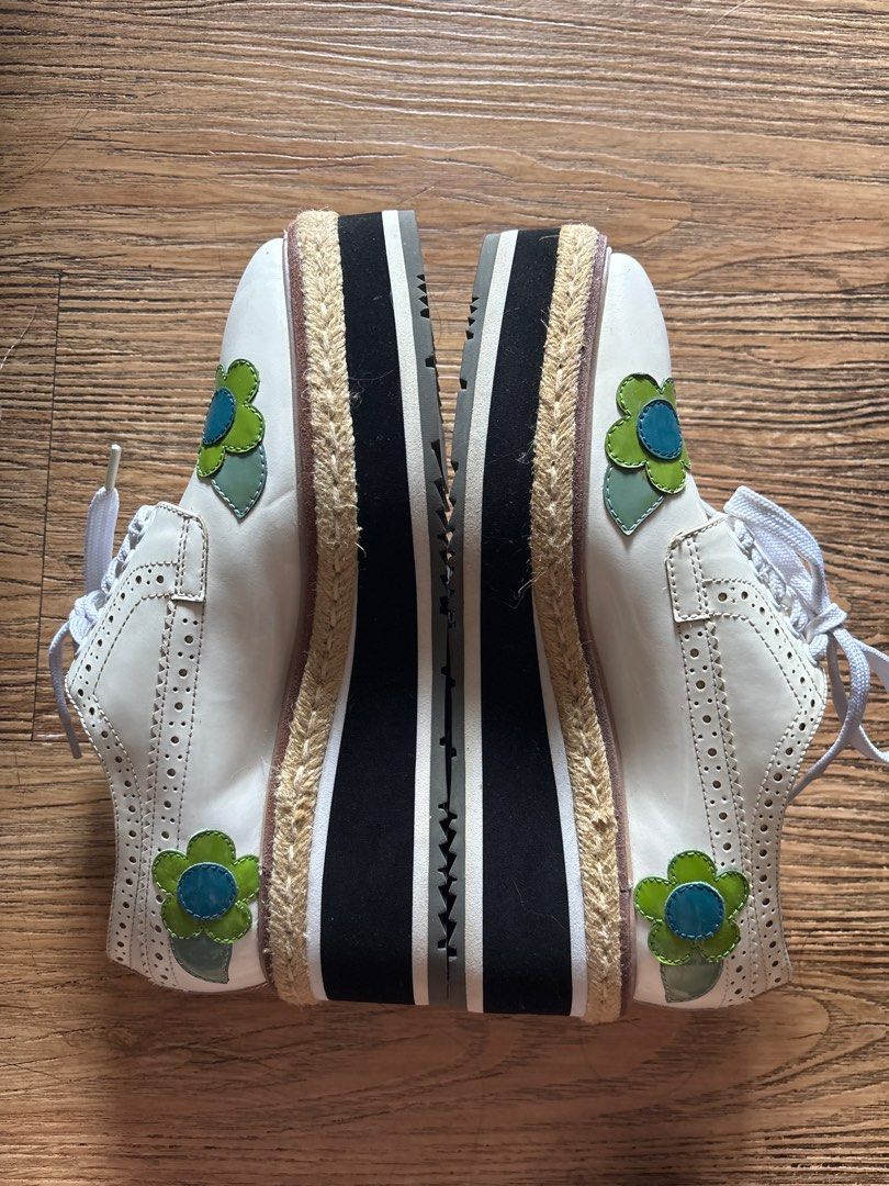 Floral Platform Shoes (Category: Sneakers & Footwear) located in Pasig City. Submitted by bauchell (Listing ID 1412349677, Image 2). Description: - White platform shoes - Floral appliques (blue and green) - Thick platform sole with rope trim - Black soles with Prada logo - White laces - Decorative perforations - Stored for quite some time - Price negotiable Please manage your expectations..