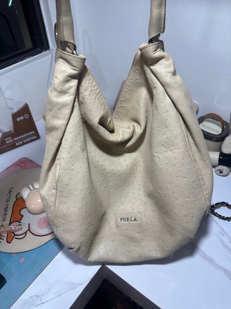 Furla Hobo Bag (Category: Luxury Bags & Wallets) located in Quezon City. Submitted by aceccrts (Listing ID 1412487580, Image 1). Description: - Original Cream-colored Furla hobo bag - Textured leather exterior - Comfortable single shoulder strap - Spacious interior - Features the Furla logo Dimensions: Width (at bottom): Around 14 inches (approx. 36 cm). Height: Approximately 33-38 cm (13-15 inches). Depth: Around 12-14 cm (4.7-5.5 inches). Handl