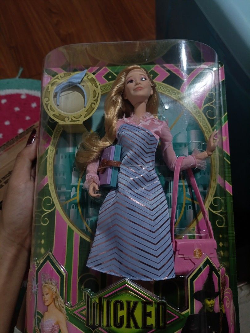 GLINDA SHIZ UNIVERSITY DOLL (Category: Figurines & Statues) located in Cavite. Submitted by yukichanito1995 (Listing ID 1412502776, Image 1). Description: WILLING TO TRADE FOR DELUXE GLINDA PART 1 -got her for 3,500 pesos - Glinda doll from the musical Wicked - Features a light blue and pink dress - Includes a pink handbag and headband - Doll has no box (seller will provide).