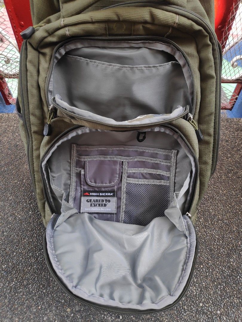 High Sierra Wheeled Backpack (Category: Backpacks) located in Quezon City. Submitted by j.c.declutter (Listing ID 1412358109, Image 3). Description: - High Sierra rolling backpack - Durable construction - Multiple compartments for organization - Padded laptop sleeve - Retractable handle for easy rolling - Adjustable shoulder straps - Cushioned back panel for comfort - Green exterior with multiple pockets - Original Price 4000.