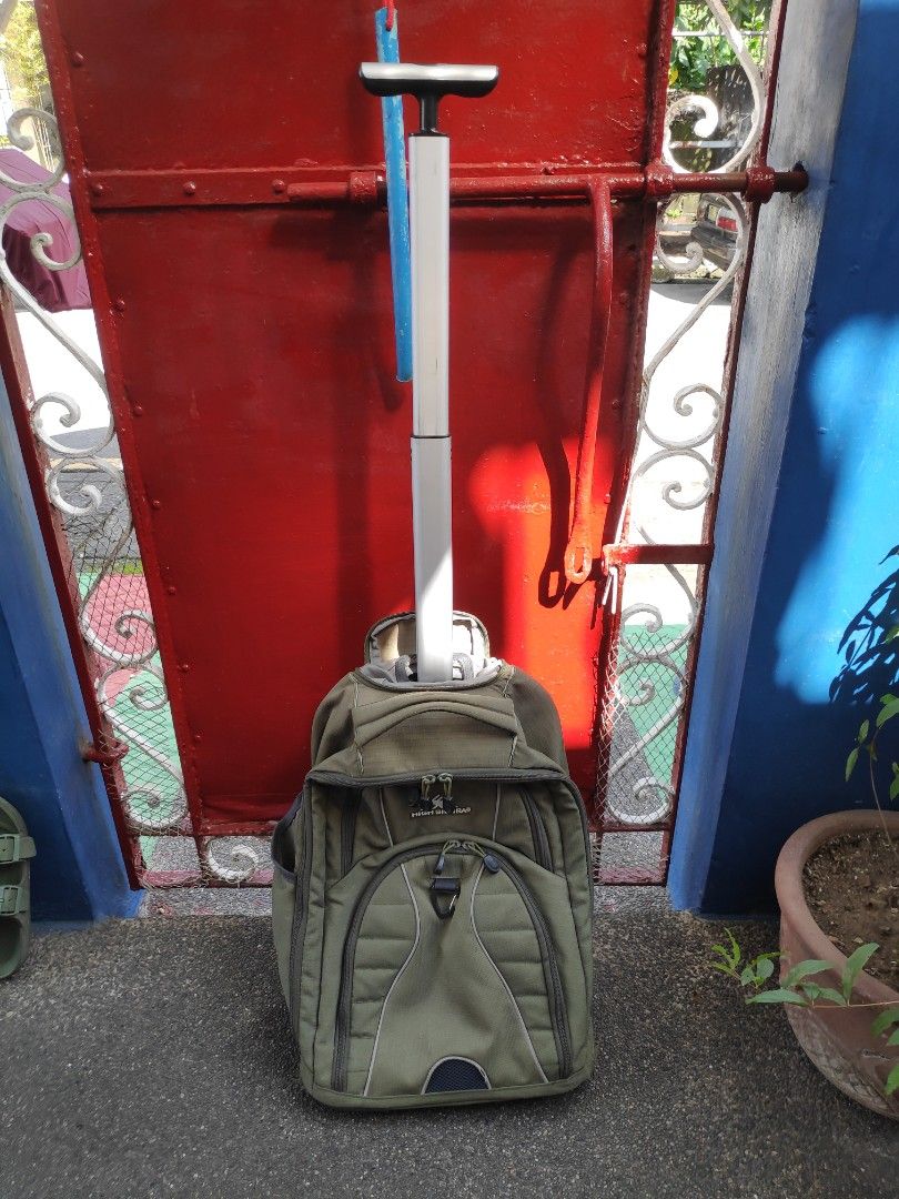 High Sierra Wheeled Backpack (Category: Backpacks) located in Quezon City. Submitted by j.c.declutter (Listing ID 1412358109, Image 2). Description: - High Sierra rolling backpack - Durable construction - Multiple compartments for organization - Padded laptop sleeve - Retractable handle for easy rolling - Adjustable shoulder straps - Cushioned back panel for comfort - Green exterior with multiple pockets - Original Price 4000.
