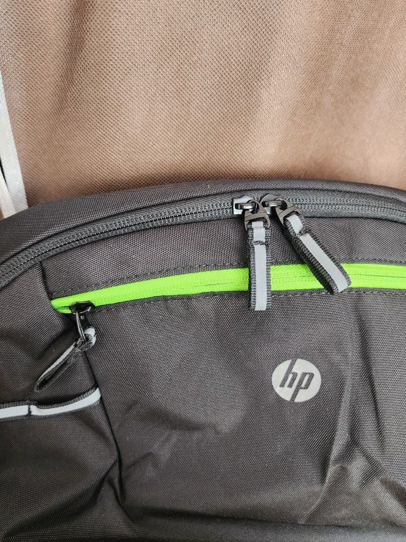 HP Gaming Backpack (Category: Backpacks) located in Santo Tomas. Submitted by mieu_declutters (Listing ID 1412387517, Image 3). Description: - Bought in Malaysia - Sleek black HP backpack with green accents. - Dedicated laptop sleeve. - Multiple compartments for organization. - Comfortable padded shoulder straps. - Reflective details for enhanced visibility. - Spacious interior, perfect for everyday use..