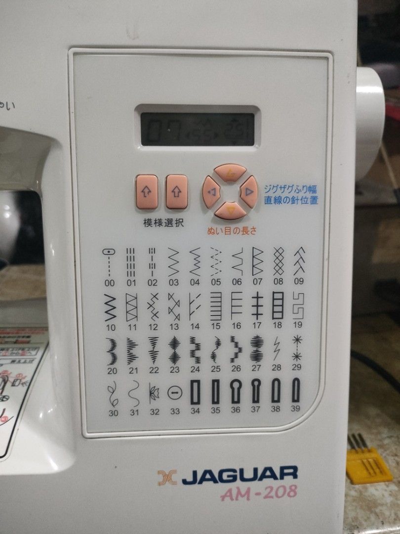 Jaguar AM-208 Sewing Machine (Category: Craft Supplies & Tools) located in Manila. Submitted by faststone-c3c8 (Listing ID 1412514275, Image 2). Description: Jaguar AM-208 sewing machine. Features a variety of stitch patterns and an LCD display. The machine has a white body with a control panel for stitch selection and settings. Includes a built-in light and a needle threader. The machine is shown with a piece of fabric under the needle..