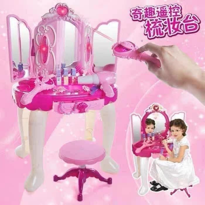Kids' Pink Vanity Table Set (Category: Tables & Sets) located in Manila. Submitted by raredeer-4deb4e (Listing ID 1412403211, Image 2). Description: - Pink vanity table set for little girls - Includes a table, mirror, and stool - Comes with a hairdryer and pretend makeup accessories - Features a drawer for storage - Adjustable side mirrors - Designed with a fun princess theme.