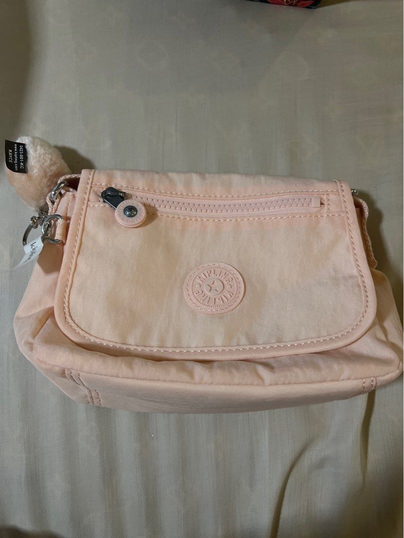 Kipling Crossbody Bag - Peach color (Category: Cross-body Bags) located in San Fernando. Submitted by _prelovedbysflp (Listing ID 1412428294, Image 1). Description: Kipling Sabian $54 = ₱ 3,177.20 .
