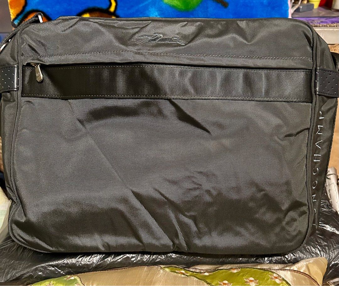 Longchamp Messenger Bag (Category: Luxury Bags & Wallets) located in Quezon City. Submitted by asiaco (Listing ID 1412434936, Image 2). Description: Longchamp messenger bag in black. Features multiple compartments, shoulder strap, and Longchamp logo. Made in Tunisia. Almost new. .