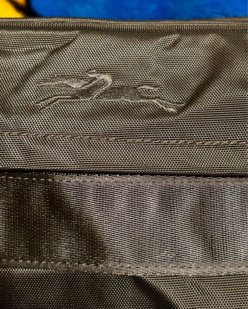 Longchamp Messenger Bag (Category: Luxury Bags & Wallets) located in Quezon City. Submitted by asiaco (Listing ID 1412434936, Image 3). Description: Longchamp messenger bag in black. Features multiple compartments, shoulder strap, and Longchamp logo. Made in Tunisia. Almost new. .