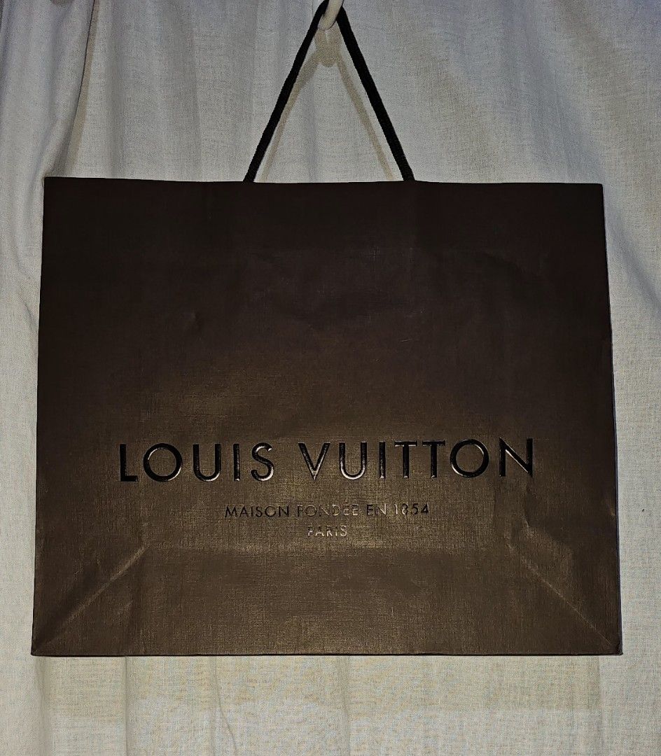 Louis Vuitton Paper Bag (Category: Luxury Bags & Wallets) located in San Jose del Monte. Submitted by stellarbeauty (Listing ID 1412424712, Image 1). Description: - Authentic Louis Vuitton paper bag - Features the iconic Louis Vuitton logo - Classic brown color - Black handles - Perfect for gifts or collectors - A stylish accessory 2 pcs available.