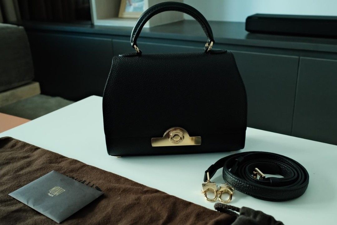 Moynat Rejane Handbag Black (Category: Luxury Bags & Wallets) located in Makati City. Submitted by roguetrader12 (Listing ID 1412457863, Image 1). Description: Measures: 20cm L x 15cm H x 8cm W (approx) Comes with a detachable strap, dust bag, shopping bag, and box Material: Taurillon Leather Hardware: Gold Hardware Purchase History: Bought in Paris, France Made in France Complete Authenticity Card and Care Cards Retail Price: €4,000 PHP 225,000 