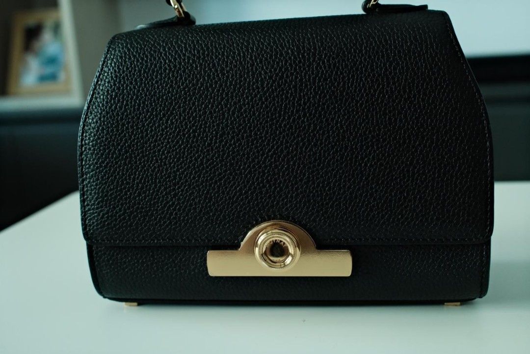 Moynat Rejane Handbag Black (Category: Luxury Bags & Wallets) located in Makati City. Submitted by roguetrader12 (Listing ID 1412457863, Image 3). Description: Measures: 20cm L x 15cm H x 8cm W (approx) Comes with a detachable strap, dust bag, shopping bag, and box Material: Taurillon Leather Hardware: Gold Hardware Purchase History: Bought in Paris, France Made in France Complete Authenticity Card and Care Cards Retail Price: €4,000 PHP 225,000 