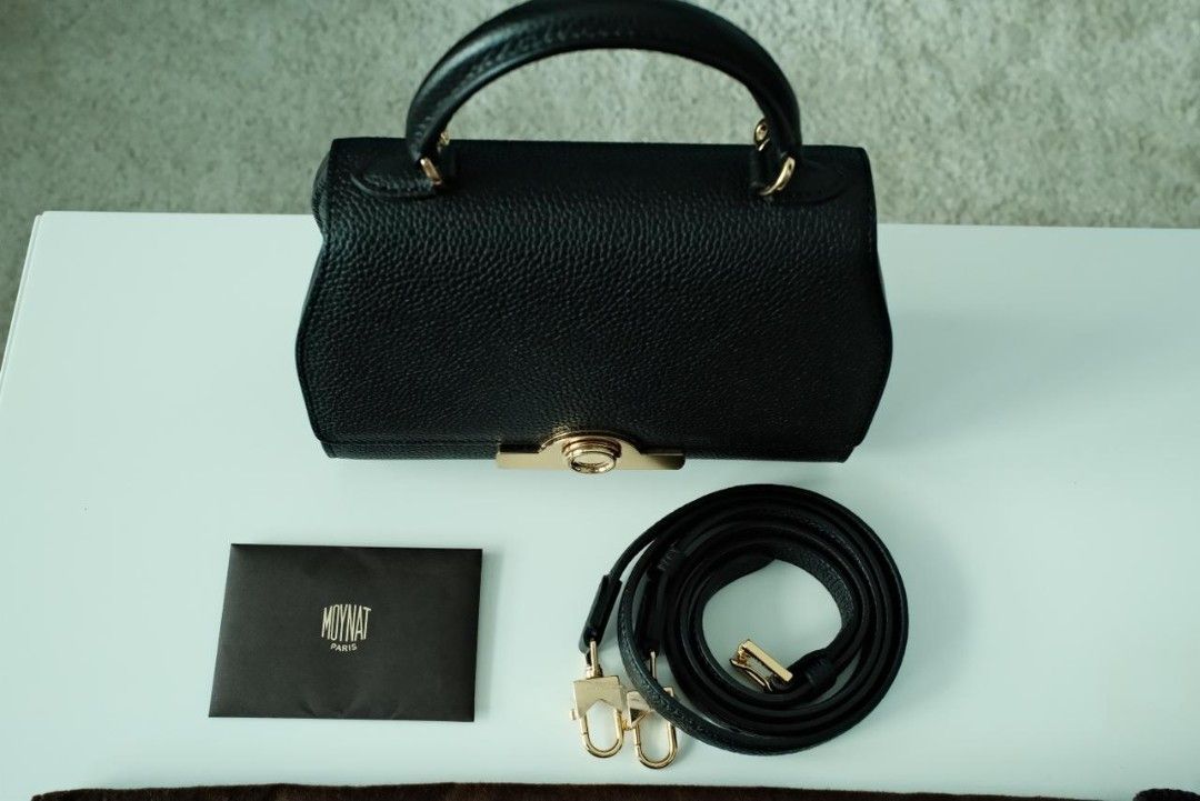 Moynat Rejane Handbag Black (Category: Luxury Bags & Wallets) located in Makati City. Submitted by roguetrader12 (Listing ID 1412457863, Image 2). Description: Measures: 20cm L x 15cm H x 8cm W (approx) Comes with a detachable strap, dust bag, shopping bag, and box Material: Taurillon Leather Hardware: Gold Hardware Purchase History: Bought in Paris, France Made in France Complete Authenticity Card and Care Cards Retail Price: €4,000 PHP 225,000 
