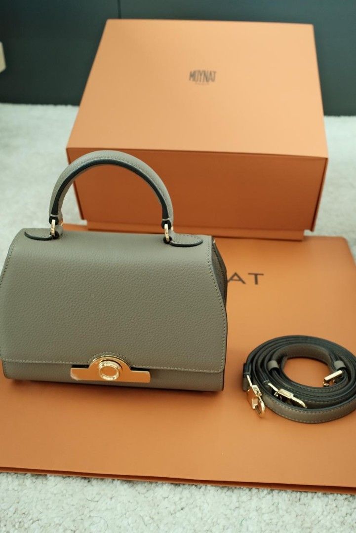 Moynat Rejane Handbag Black (Category: Luxury Bags & Wallets) located in Makati City. Submitted by roguetrader12 (Listing ID 1412458175, Image 1). Description: Measures: 20cm L x 15cm H x 8cm W (approx) Comes with a detachable strap, dust bag, shopping bag, and box Material: Taurillon Leather Hardware: Gold Hardware Purchase History: Bought in Paris, France Made in France Complete Authenticity Card and Care Cards Retail Price: €4,000 PHP 225,000 