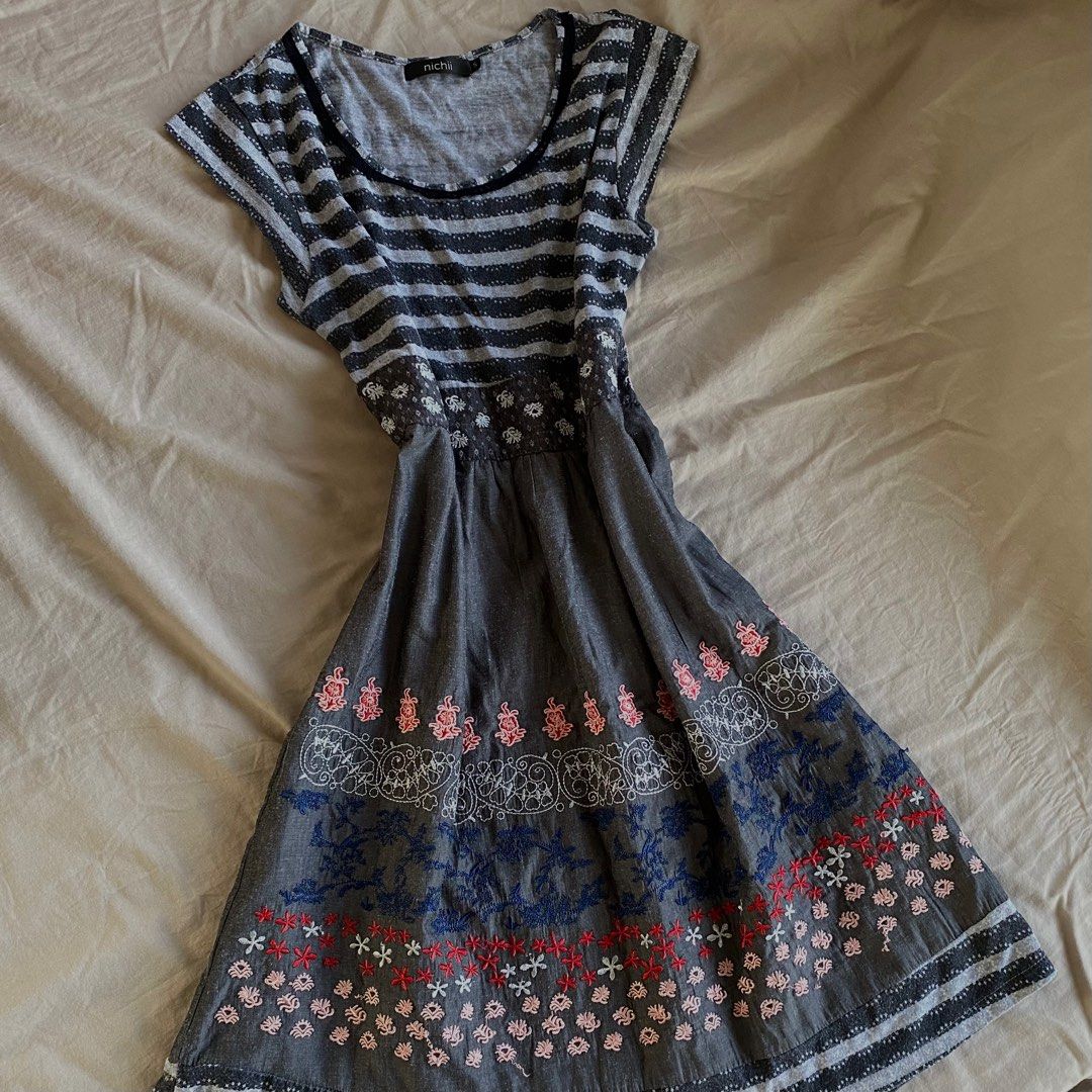 Nichii Embroidered Dress (Category: Dresses) located in Dagupan City. Submitted by imrhnnh (Listing ID 1412338251, Image 1). Description: - Nichii dress - Striped top - Embroidered skirt with floral design - Round neckline with lace trim - Cap sleeves - Embroidery colors: red, blue, white.