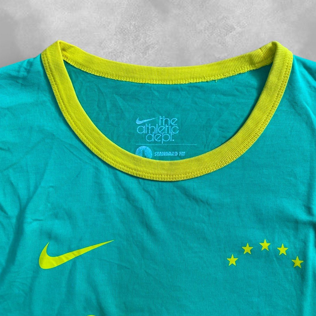 Nike Athletic Dept. DFC T-shirt (Category: Tshirts & Polo Shirts ) located in Cebu City. Submitted by peakstuffs (Listing ID 1412370881, Image 2). Description: - Nike Athletic Dept. t-shirt - Teal body with yellow collar and sleeve accents - Features "DFC" logo on the front - Includes Nike logo and stars - Authentic Nike product (see tag for product code).