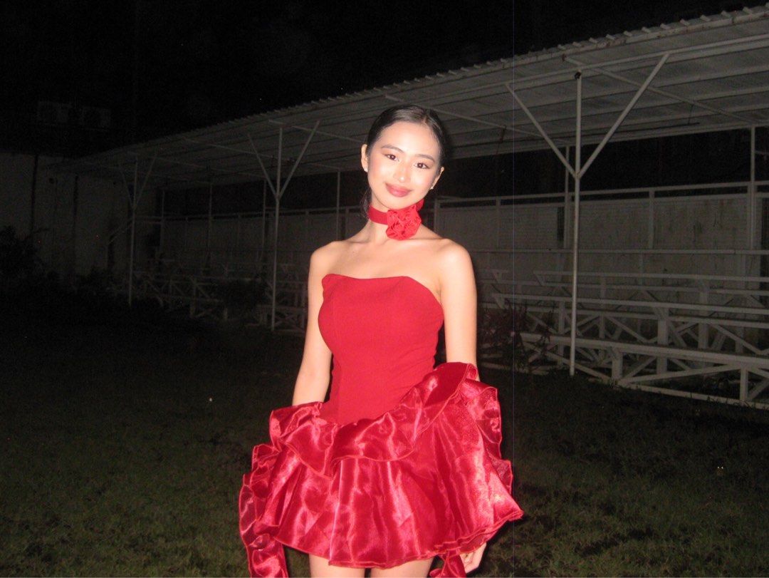 Shein Red Mini Dress (Category: Dresses) located in Daet. Submitted by calli.declutter (Listing ID 1412456954, Image 2). Description: - Used once in an event - Can fit xs-s - Red strapless mini dress - Fitted bodice and ruffled skirt - Includes matching red choker with rose detail - Perfect for special occasions - Made of shiny, satin-like fabric - Flattering silhouette.