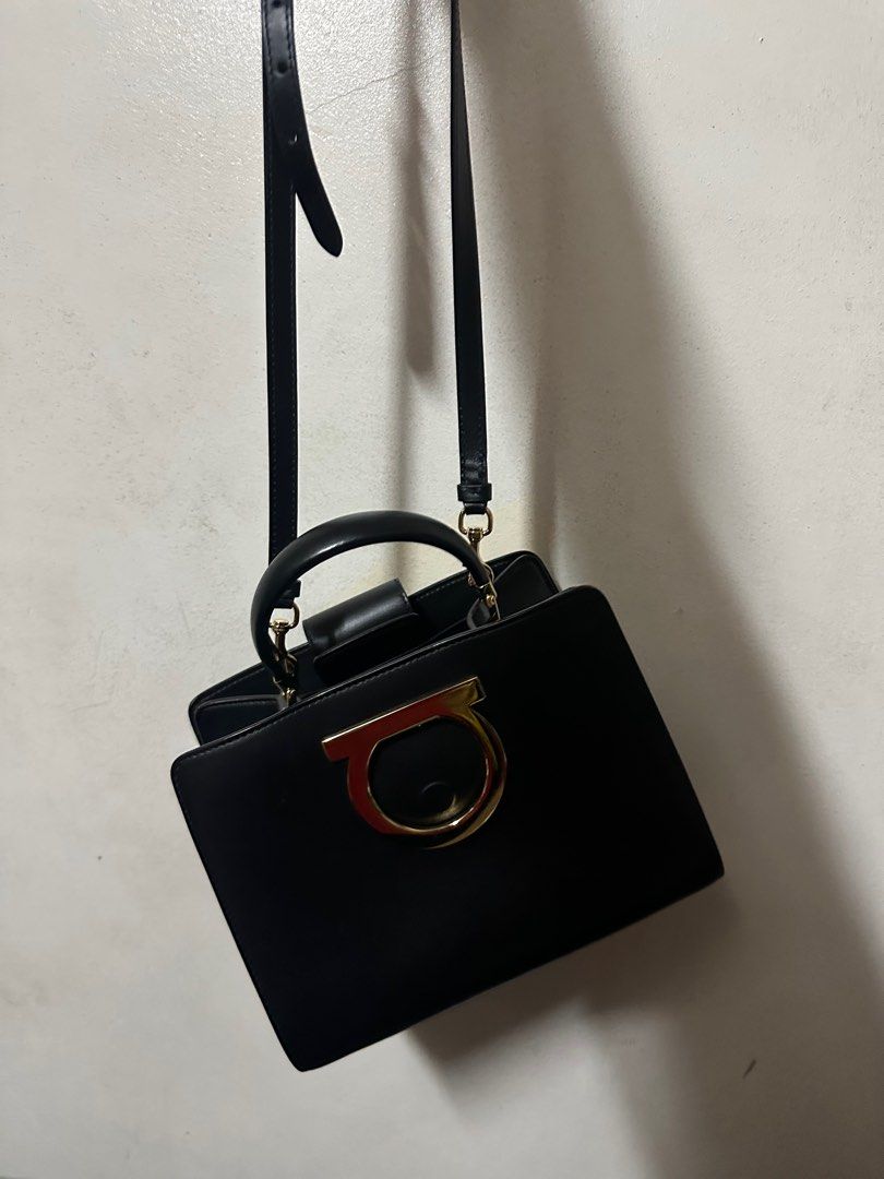 Salvatore Ferragamo Thalia Top Handlebag (Category: Luxury Bags & Wallets) located in Del Monte. Submitted by jojedi (Listing ID 1412332206, Image 2). Description: - Salvatore Ferragamo black handbag - Gold-tone clasp and hardware - Includes top handle and detachable shoulder strap - Interior zippered pocket - Brand label: "Salvatore Ferragamo Made in Italy" - Rectangular shape.