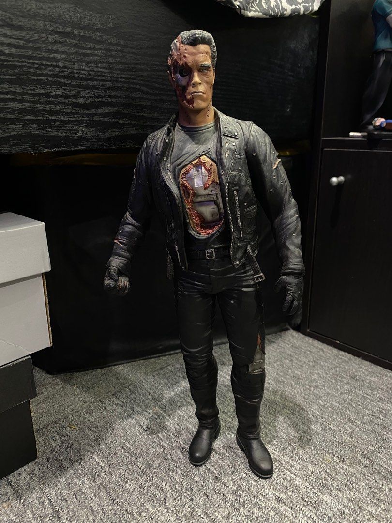 Terminator 2 T-800 Endoskeleton Action Figure (Category: Figurines & Statues) located in President Roxas. Submitted by isserminator (Listing ID 1412436010, Image 1). Description: - T-800 Terminator action figure from Terminator 2. - Damaged exterior revealing endoskeleton. - Black leather jacket, pants, and boots. - Detailed face sculpt with endoskeleton details. - Standing upright pose..