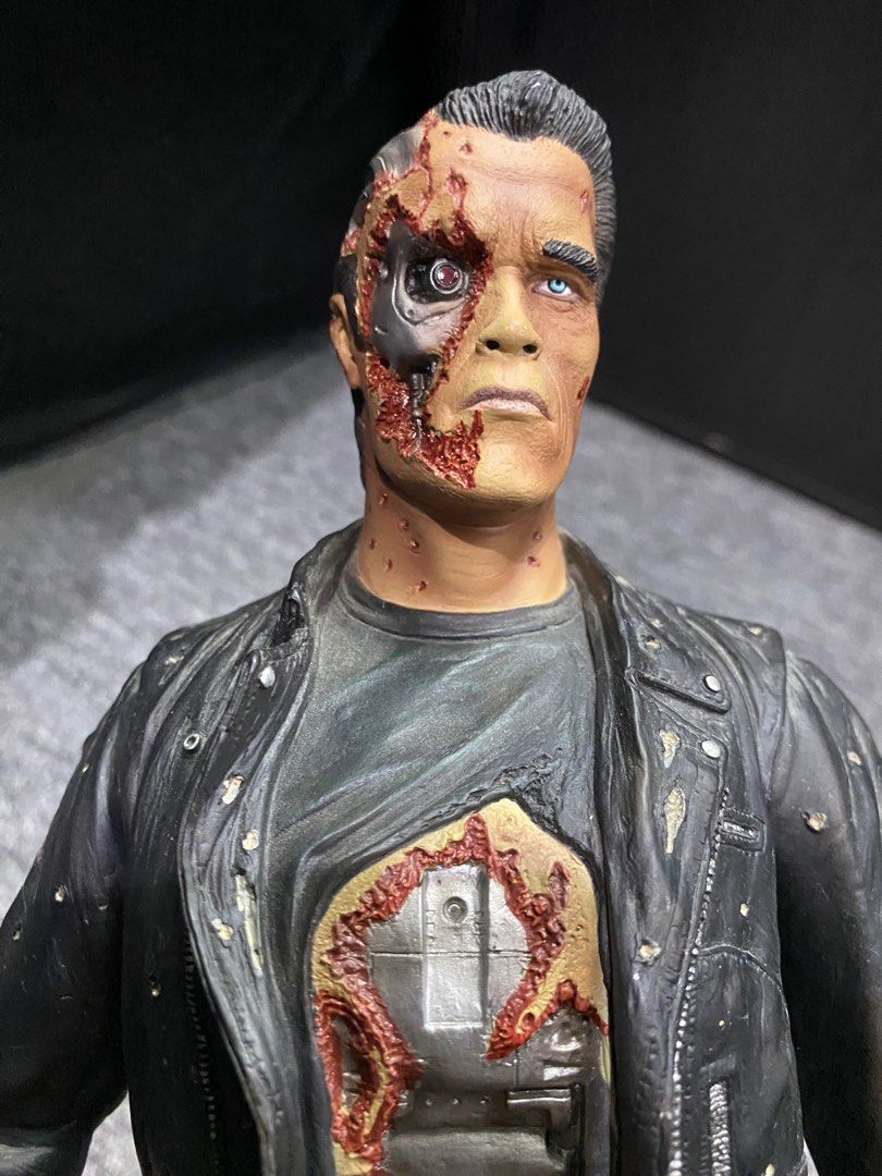 Terminator 2 T-800 Endoskeleton Action Figure (Category: Figurines & Statues) located in President Roxas. Submitted by isserminator (Listing ID 1412436010, Image 2). Description: - T-800 Terminator action figure from Terminator 2. - Damaged exterior revealing endoskeleton. - Black leather jacket, pants, and boots. - Detailed face sculpt with endoskeleton details. - Standing upright pose..