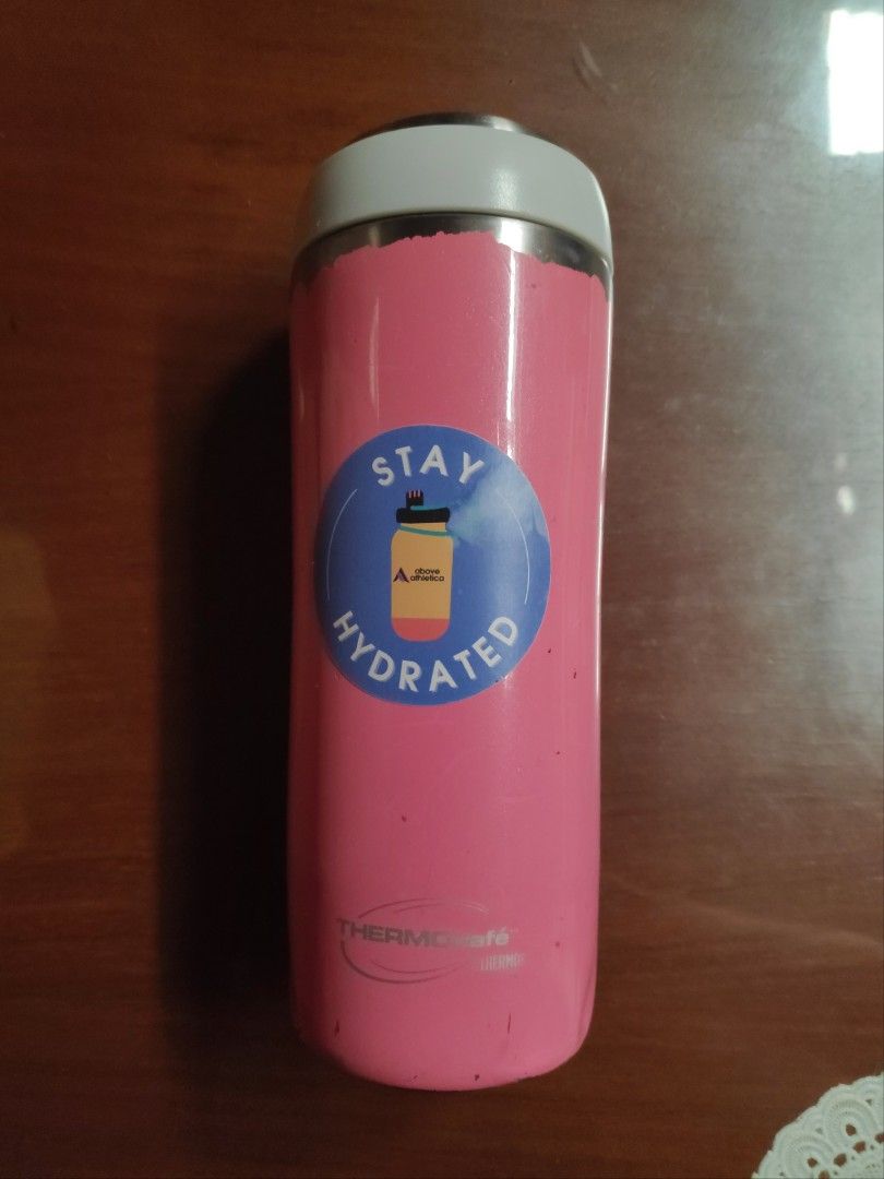 Thermos Tumbler - Pink (Category: Water Bottles & Tumblers) located in Quezon City. Submitted by j.c.declutter (Listing ID 1412365394, Image 1). Description: - Pink Thermos tumbler - White lid - Features a "Stay Hydrated" sticker - Stainless steel construction - Clean interior - Convenient size for portability - Removable lid for easy cleaning.