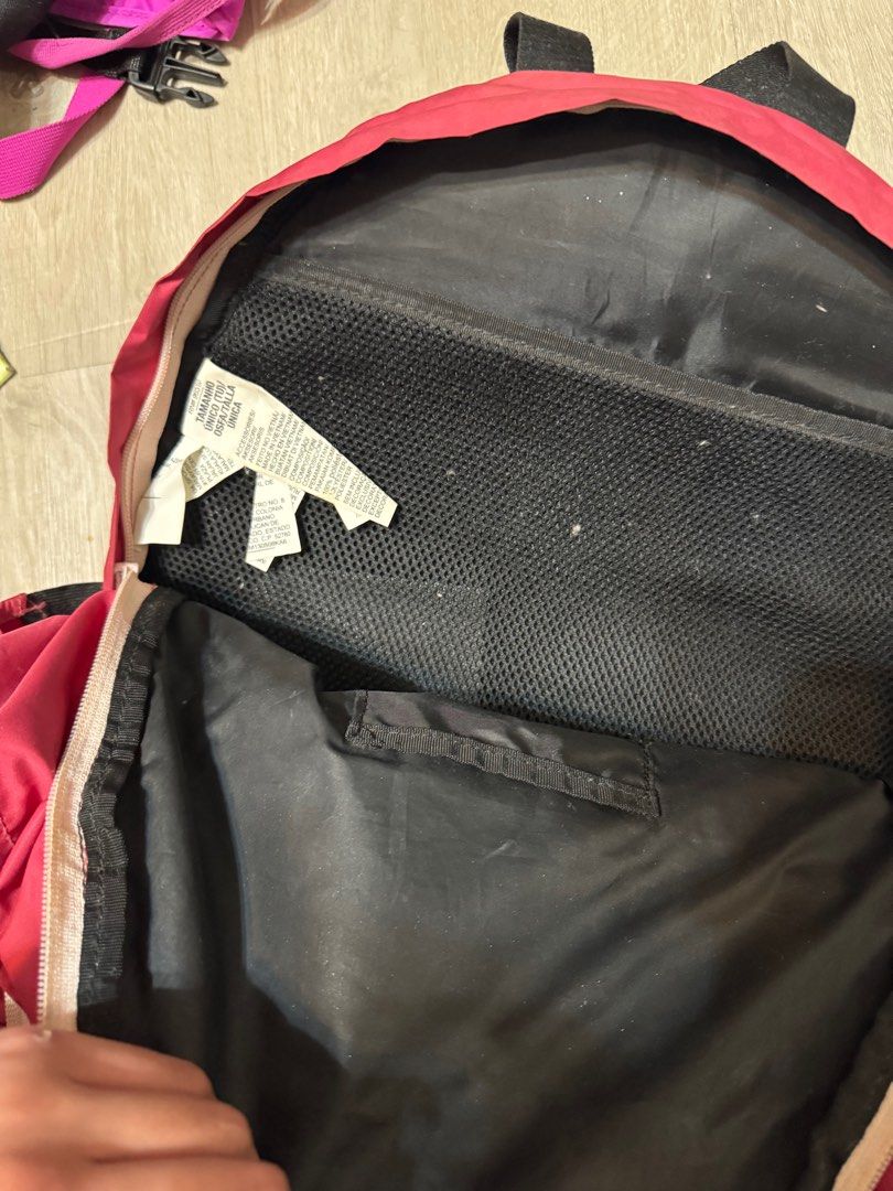 Under Armour Backpack (Category: Backpacks) located in Taguig. Submitted by whitechocolatechip (Listing ID 1412410963, Image 3). Description: - Red Under Armour backpack with black handle and straps. - Front pocket with Under Armour logo. - Multiple interior compartments, including a mesh pocket. - Zipper closure for security. - Adjustable straps for a comfortable fit. - Perfect for daily use - needs cleaning.