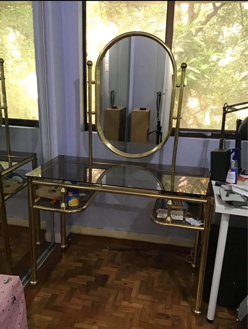 Vintage Gold Vanity Table with Mirror brass (Category: Tables & Sets) located in Quezon City. Submitted by psc2nd (Listing ID 1412443899, Image 1). Description: - Vintage vanity table - brass-colored frame - Glass top - Attached oval mirror - Lower storage shelf - Curved accents - Classic aesthetic - Perfect for bedroom or dressing area item is for pickup at current lication is quezon city… might have to be brought down from 4th floor to the grou