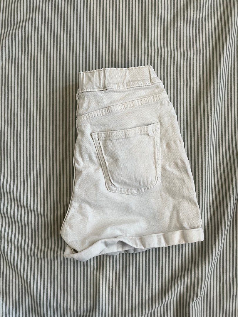 White denim shorts (Category: Shorts) located in Paranaque City. Submitted by mandsss21 (Listing ID 1412367190, Image 2). Description: - Cream-colored shorts - Elastic waistband - Front pockets - Button closure - Back pocket - Rolled hem - Perfect for casual wear.