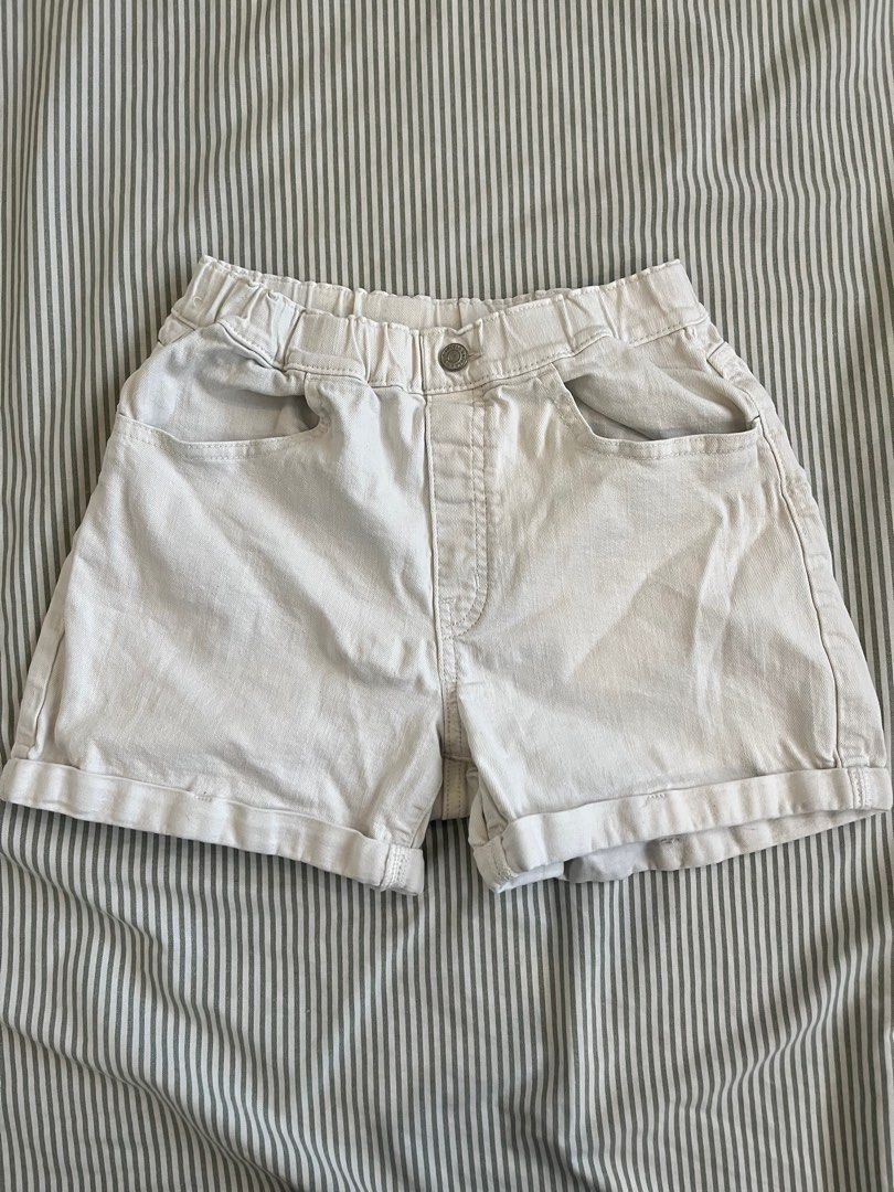 White denim shorts (Category: Shorts) located in Paranaque City. Submitted by mandsss21 (Listing ID 1412367190, Image 1). Description: - Cream-colored shorts - Elastic waistband - Front pockets - Button closure - Back pocket - Rolled hem - Perfect for casual wear.