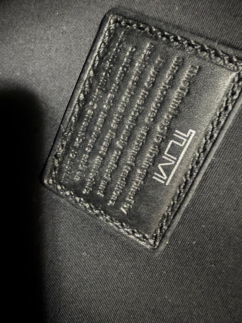 Authentic Tumi Black Briefcase (laptop bag) (Category: Briefcases) located in Pasig City. Submitted by mswise (Listing ID 1406517146, Image 3). Description: - Black Tumi briefcase - Includes shoulder strap and top handles - Features a front pocket - Metal Tumi logo - Comes with a Tumi card - Made of durable, possibly nylon, material - Simple and professional design Measurement 16 x 11 x 3 inches.