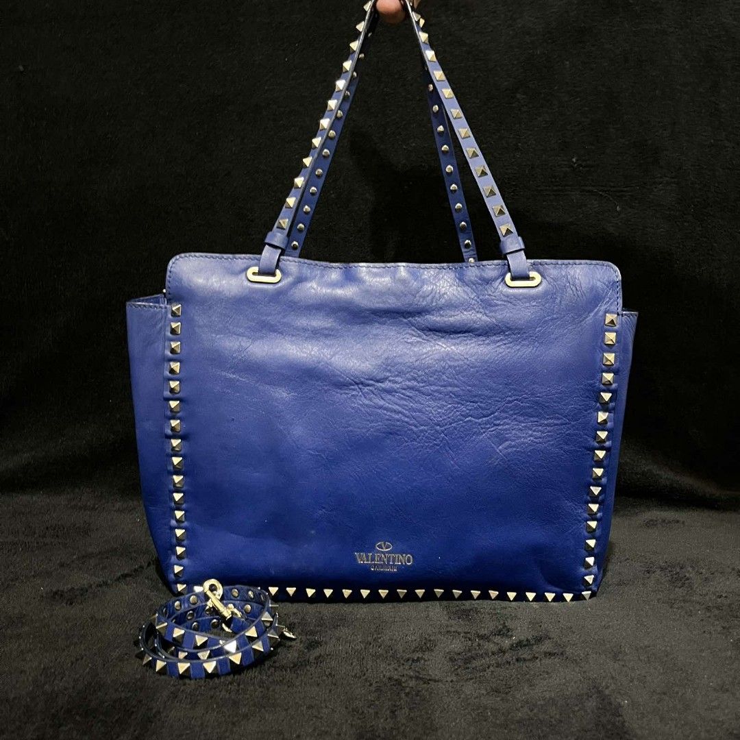 Authentic Valentino Garavani Rockstud Tote Bag (Category: Luxury Bags & Wallets) located in Manila. Submitted by mkalelx (Listing ID 1407574318, Image 1). Description: FOR SALE: VALENTINO GARAVANI Rockstud Small Calfskin Leather 2-Ways Tote Bag Blue •Price: 30,000PHP OR BEST OFFER •Authentic •Location: Antipolo •Meetup: Robinsons Antipolo •Can ship via LBC, Lalamove, J&T. •Buyer shoulders the shipping fee. •Condition: This previously owned and us