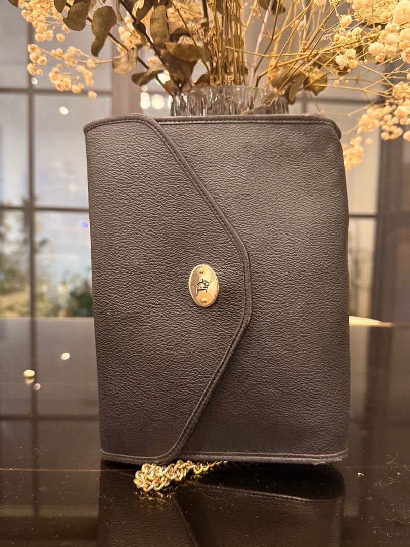 Christian Dior Black Shoulder Bag with Chain (Category: Luxury Bags & Wallets) located in Cavite. Submitted by kleaningoutmykloset (Listing ID 1407646597, Image 1). Description: - Christian Dior black shoulder bag - Gold chain strap - Flap closure with Dior emblem - Authentic Christian Dior label - Textured leather exterior - Classic and stylish design.