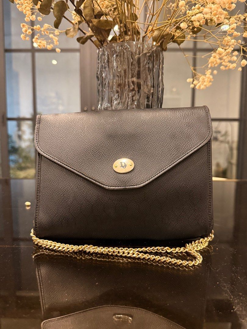 Christian Dior Black Shoulder Bag with Chain (Category: Luxury Bags & Wallets) located in Cavite. Submitted by kleaningoutmykloset (Listing ID 1407646597, Image 2). Description: - Christian Dior black shoulder bag - Gold chain strap - Flap closure with Dior emblem - Authentic Christian Dior label - Textured leather exterior - Classic and stylish design.