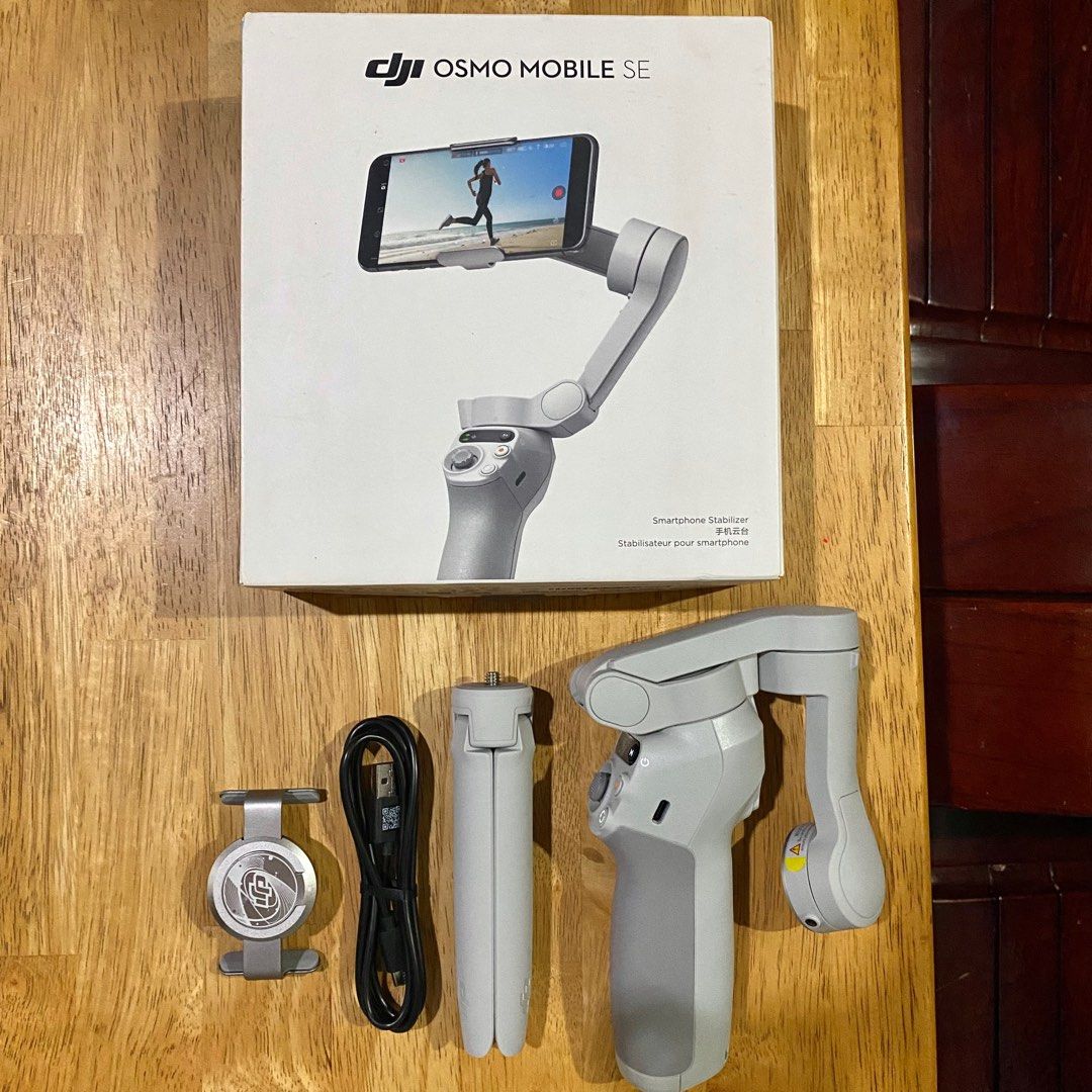 DJI Osmo Mobile SE Smartphone Stabilizer (Category: Gimbals & Stabilizers ) located in Bulacan. Submitted by puzzles_piece (Listing ID 1407673582, Image 1). Description: Not even used, just opened No issue and comes with all the inclusions Includes: Stabilizer, tripod, charging cable, phone clamp, and box.