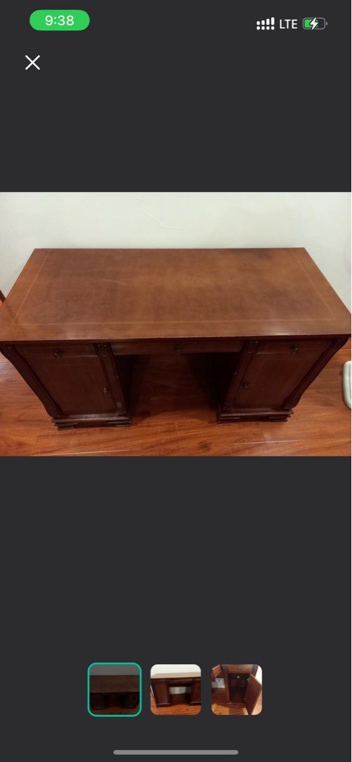 Hardwood Study Table (Category: Tables & Sets) located in Quezon City. Submitted by tanniecartz (Listing ID 1407576399, Image 2). Description: - Dark wood desk with a spacious top - Features multiple drawers and cabinets - Includes decorative carvings - Provides ample storage for office supplies - Ideal for home or office use.