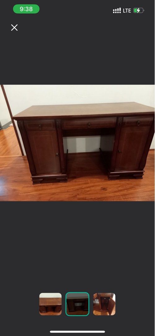 Hardwood Study Table (Category: Tables & Sets) located in Quezon City. Submitted by tanniecartz (Listing ID 1407576399, Image 3). Description: - Dark wood desk with a spacious top - Features multiple drawers and cabinets - Includes decorative carvings - Provides ample storage for office supplies - Ideal for home or office use.