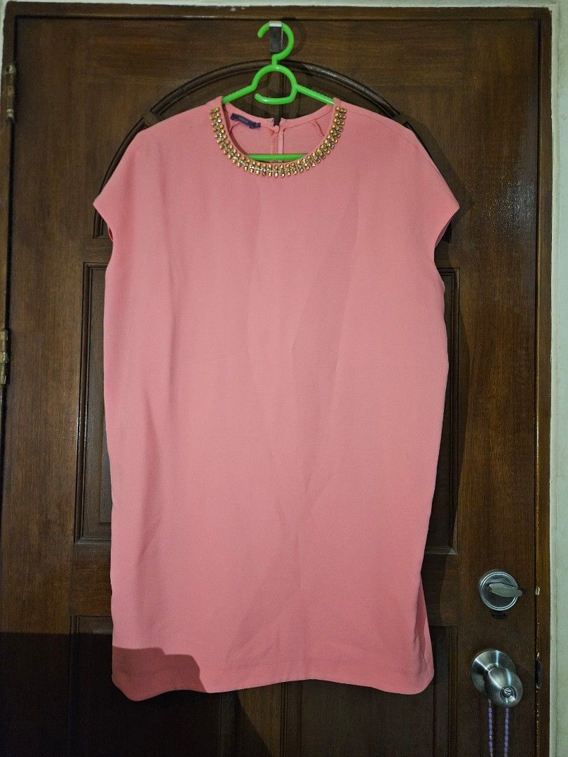 Jessica Pink Dress (Category: Dresses) located in Pasig City. Submitted by simdeclutters (Listing ID 1407738222, Image 1). Description: Top features a round neckline adorned with embellishments. It has short sleeves and a simple design. The top is a solid pink color. The tag indicates the brand is Jessica and the size is 12..