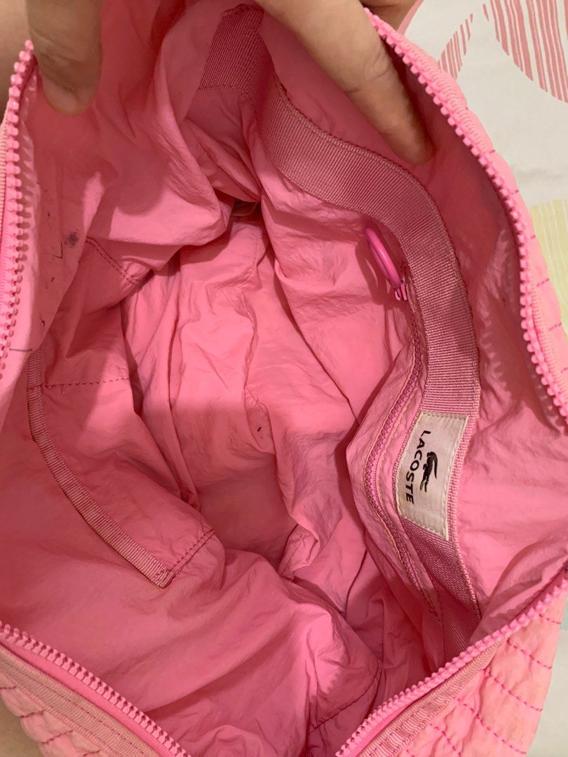 Lacoste Pink Cross body Bag (Category: Cross-body Bags) located in Pasig City. Submitted by newmoon-45bc (Listing ID 1407704312, Image 2). Description: - Lacoste pink crossbody bag - Quilted design - Good overall condition but with some stains (can be cleaned) - Features the Lacoste logo - Meetup locations: Boni Station, Greenfield District - Courier pick-up or delivery available.