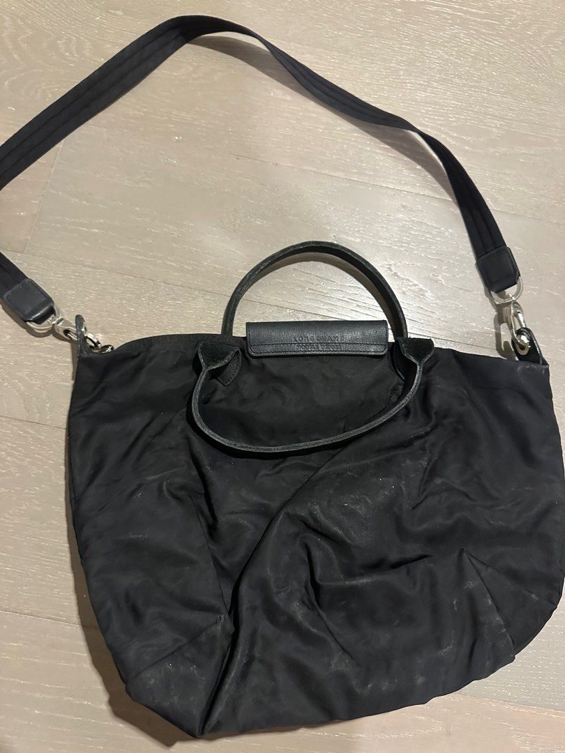 Longchamp Black Handbag with Shoulder Strap (Category: Luxury Bags & Wallets) located in Makati City. Submitted by spiffph (Listing ID 1407669223, Image 2). Description: - Black Longchamp handbag - Includes a shoulder strap and top handles - Zippered main compartment - Flap closure with a snap - Made of a nylon-like material - Silver-tone hardware - Black interior.