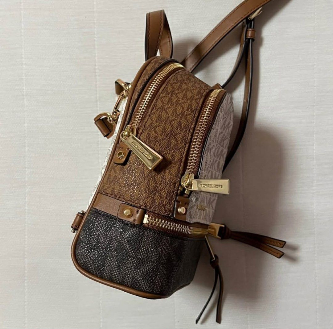 Michael Kors RHEA extra small logo backpack (Category: Luxury Bags & Wallets) located in Las Pinas. Submitted by nicoleiction (Listing ID 1407645516, Image 2). Description: - Michael Kors RHEA extra small logo backpack - Iconic MK logo design - Used only twice - No box or dust bag - Authentic from USA.
